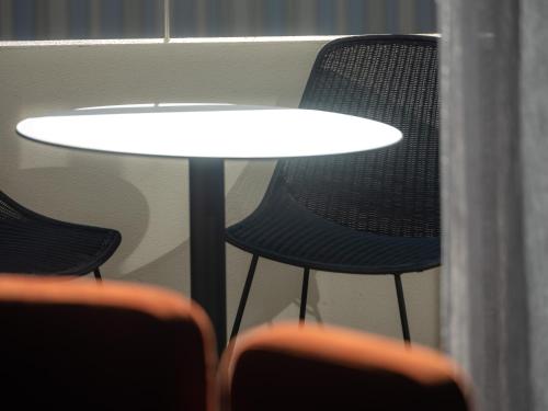 a table with two chairs next to a window at Salamanca Suites in Hobart