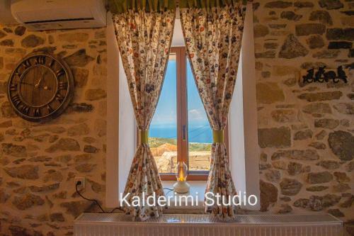 a clock and a window in a room at Kalderimi Studio in Sotír