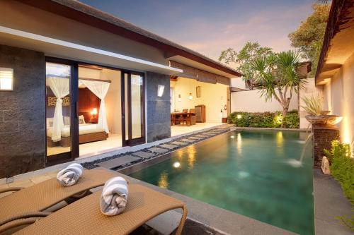 a swimming pool in the backyard of a villa at Lumbini Luxury Villas and Spa in Jimbaran