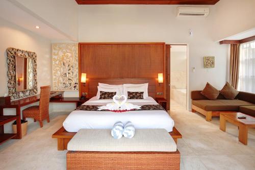 a bedroom with a bed with two white bows on it at Lumbini Luxury Villas and Spa in Jimbaran