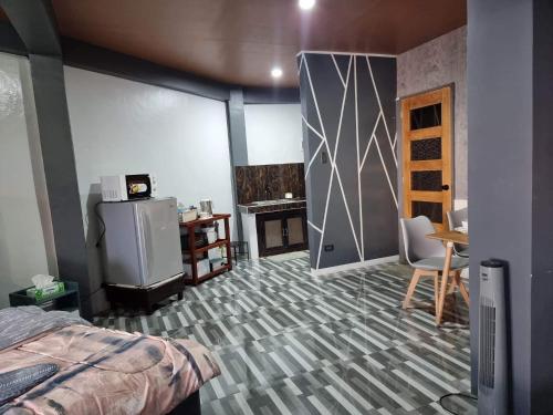 a room with a bed and a room with a fireplace at Rvenue apartelle in Lucban