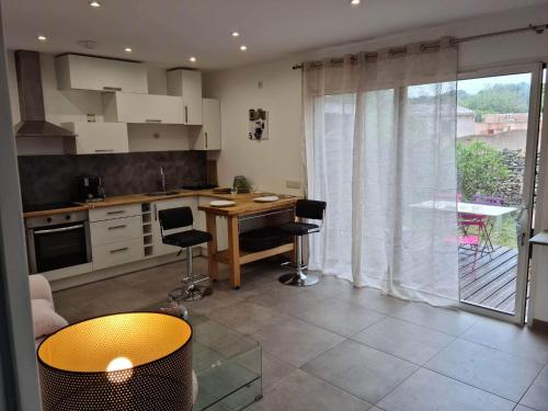 une cuisine avec une table et des chaises dans une pièce dans l'établissement La Détente, à Bonifacio