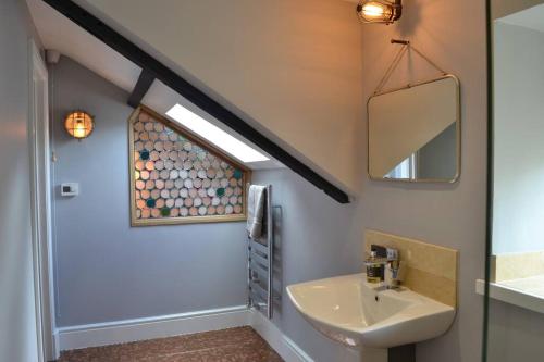 a bathroom with a sink and a mirror at No. 5 @ Ginhaus in Llandeilo