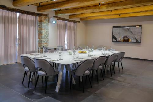 a large dining room with a white table and chairs at Via Roma 33 Tuscany Boutique Hotel & Spa - Adults Only in Stia