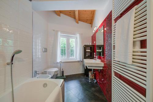 a bathroom with a tub and a sink at Villa Il Paradiso Di Gabri - Happy Rentals in Nago-Torbole