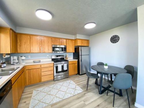 a kitchen with wooden cabinets and a table with a dining room at Madras Oak House in Madras