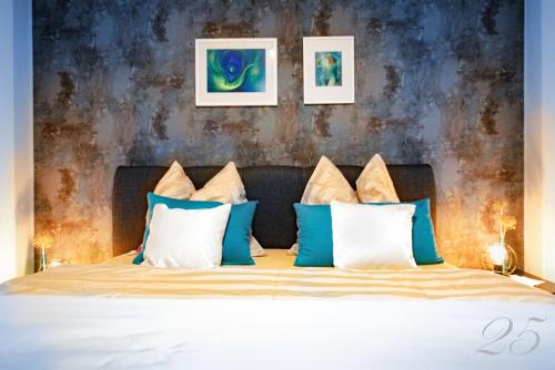 a bedroom with a bed with blue and white pillows at Ferienresidenz Am weißen Regen in Bad Koetzting