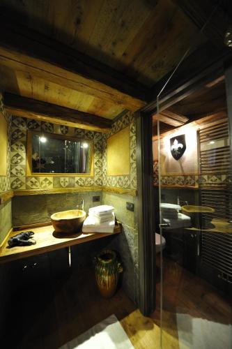 a bathroom with a sink and a mirror at Locanda dei gentili in Ossana