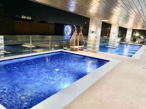 a large blue swimming pool in a building at 2313 Sun Vida Tower in Cebu City