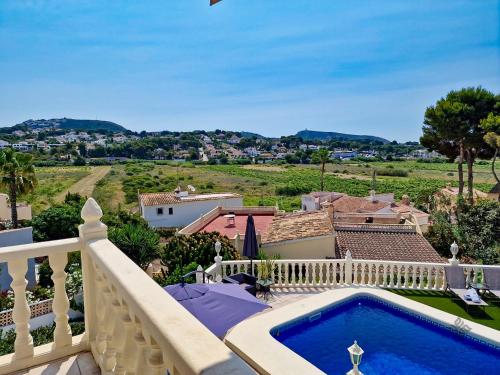a villa with a swimming pool on a balcony at Villa cerca del pueblo y playas de Moraira - Ref A022 AVANOA PREMIUM RENTALS in Moraira