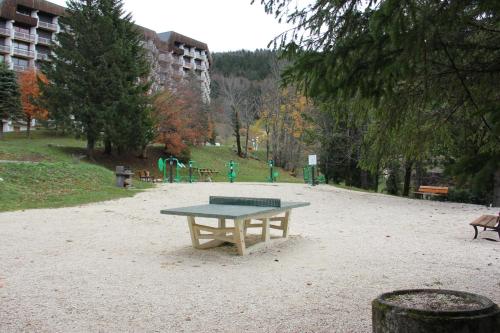 a ping pong table in the middle of a park at Au pied des pistes Côte 2000 - Le Balcon de Villard de Lans in Villard-de-Lans