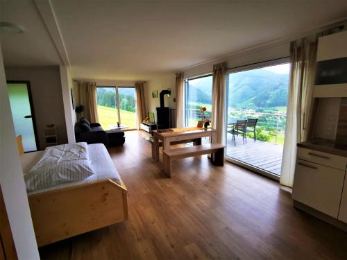 a bedroom with a bed and a living room with a view at 4 star holiday home in Gaal im Murtal in Pirkach