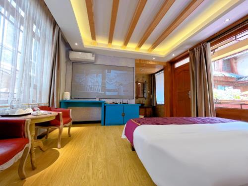 a hotel room with a bed and a projection screen at Frida's Inn 丽江梦之旅观景客栈 in Lijiang