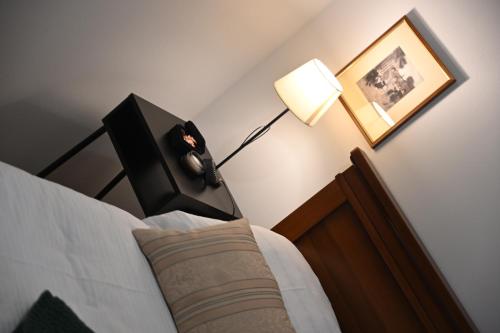 a bedroom with a bed with a clock on the headboard at Apartmani Lucija in Ludbreg