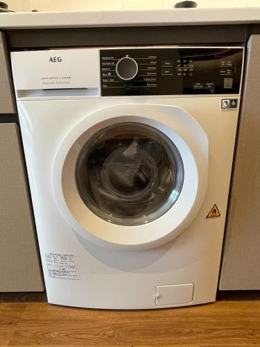 a white washing machine sitting in a kitchen at Citadines Harbour Front Yokohama in Yokohama