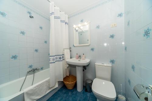 a blue and white bathroom with a sink and a toilet at Altamira, SEA & MOUNTAIN in Busturia