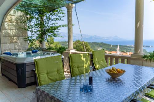 a table with a bowl of fruit on a balcony at Holiday Home Ivana in Selca