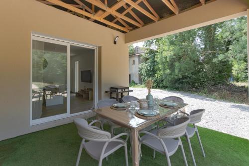 une table et des chaises sur le patio d'une maison dans l'établissement Villa Esparots - Maison avec piscine privée, à Berrias Et Casteljau