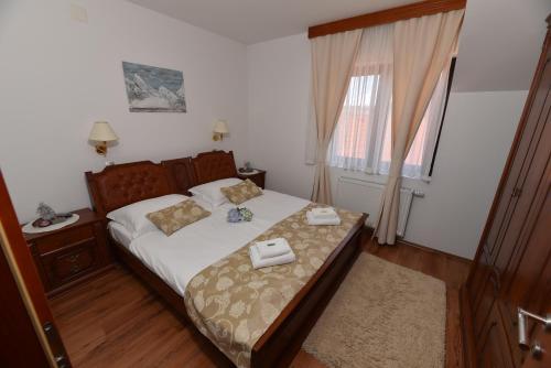 a bedroom with a bed with two towels on it at Apartmani Lucija in Ludbreg
