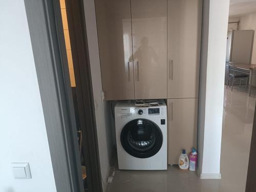 a washer and dryer in a room with cabinets at Sweetie house in Slatina