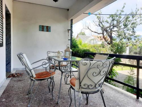 a patio with a table and chairs on a balcony at Think Blue Apartment in Nea Vrasna in Asprovalta