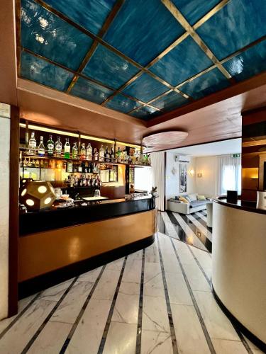a bar in a restaurant with a blue ceiling at Arthotel Gabbiano Azzurro Due in Marciana Marina