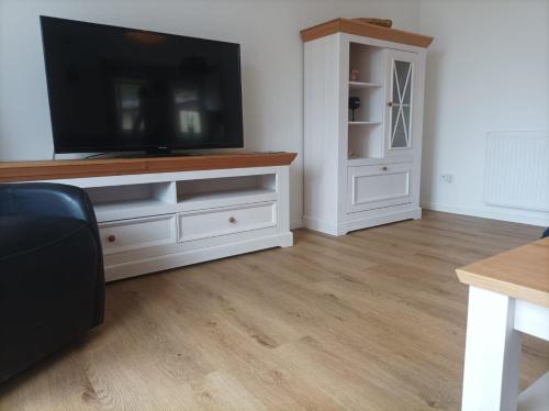 a living room with a television on a white entertainment center at Landidyll in Silenz