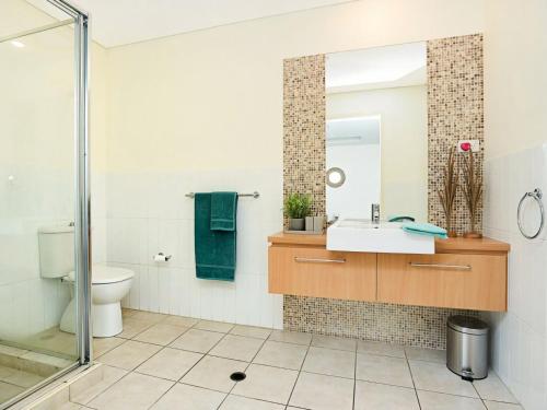 a bathroom with a sink and a mirror at Relax in Style Comfort in Victor Harbor
