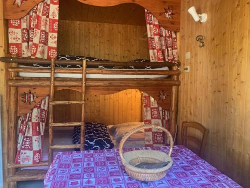 a room with a bunk bed with a basket in it at Le p'tit coin montagne in Bonneval-sur-Arc