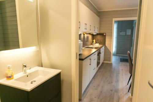 a small kitchen with a sink and a counter at Florø Rorbu in Florø