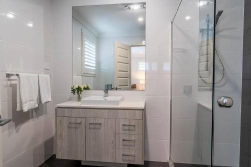 a bathroom with a sink and a shower at Sea Change in Shellharbour