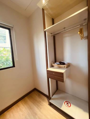 a cupboard in a room with a window at oxy suites 2-06 at Shop House Meisterstadt Pollux Habibie in Batam Center