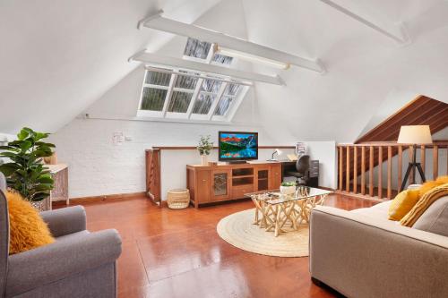 a living room with a couch and a table at Minnamurra Retreat 3 in Minnamurra