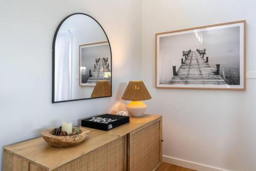 a mirror and a lamp on a dresser in a room at The White Haven of Gerringong in Gerringong