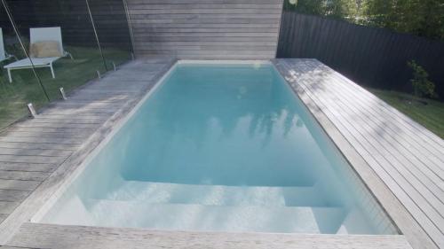 a swimming pool with a swing in a backyard at The White Haven of Gerringong in Gerringong