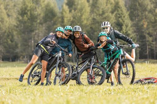 a group of people on bikes in a field at MyTime Hotels la Grotta in Vigo di Fassa
