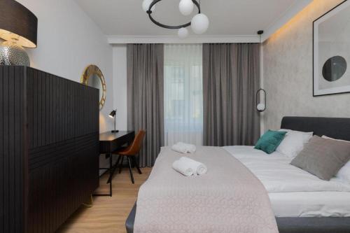 a hotel room with a bed and a desk at Double Rest in Jastrzębia Góra