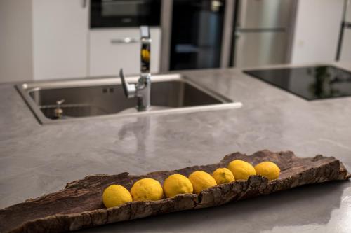 a bunch of lemons on a cutting board in a kitchen at Habitat Inn Faliraki View Villa Rhodes in Kalithies