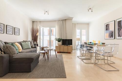 a living room with a couch and a table at Lavaderos Suites in Santa Cruz de Tenerife