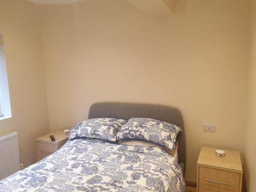 a bedroom with a bed with two pillows on it at London Luxury Apartments 3 Bedroom Sleeps 8 with 3 Bathrooms 4 mins walk to tube free parking in Ilford