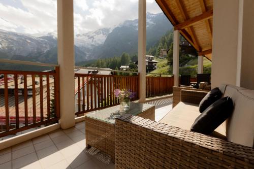 a balcony with a view of the mountains at Victoria's Home - luxurious penthouse in Saas-Fee