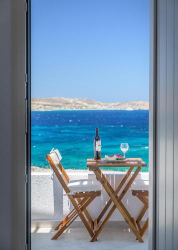 a table with a bottle of wine and a glass at Polyegos View in Pollonia