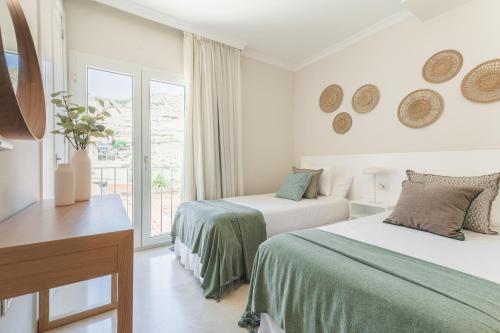 Postel nebo postele na pokoji v ubytování Lavaderos Suites