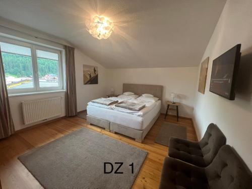a bedroom with a bed and a large window at Penthouse Appartement in Kirchberg in Tirol
