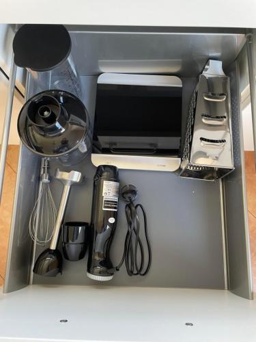 a cabinet with a microwave and other kitchen utensils at my Relaxs little Villa in Bludenz