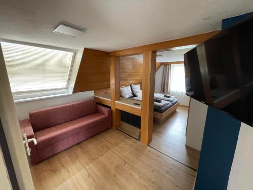 a small room with a bed and a couch at my Relaxs little Villa in Bludenz