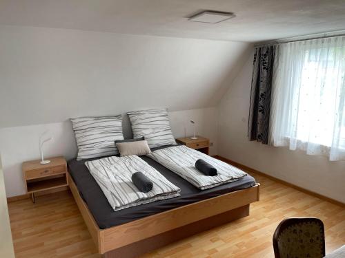 a bedroom with a large bed with two pillows at my Relaxs little Villa in Bludenz