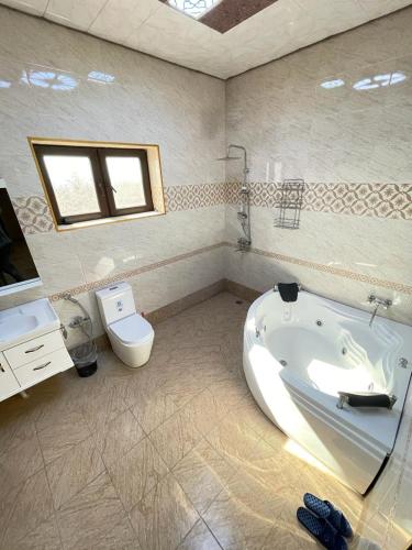 a bathroom with a bath tub and a toilet at Villa in Gabala in Gabala
