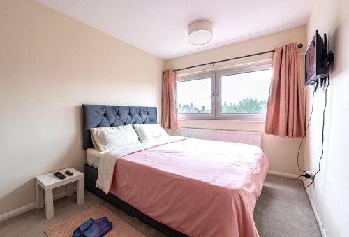 a bedroom with a bed and a window at Professional House in Kent