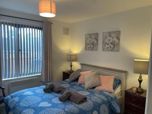 a bedroom with a bed with pillows on it at Harmony House enclosed property near beach and lake in Tramore